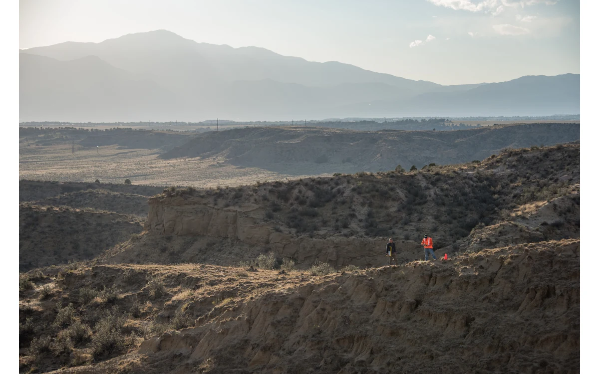 Rugged Corral Bluffs terrain with USGS scientists placing a UAS ground control target.
