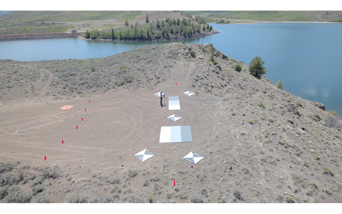 Gray-scale calibration tarps and black-and-white ground targets on land beside Willow Creek Reservoir.