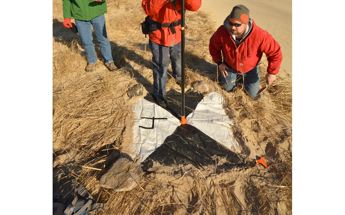 USGS ground control target and survey pole, cropped to show the physical reference point.